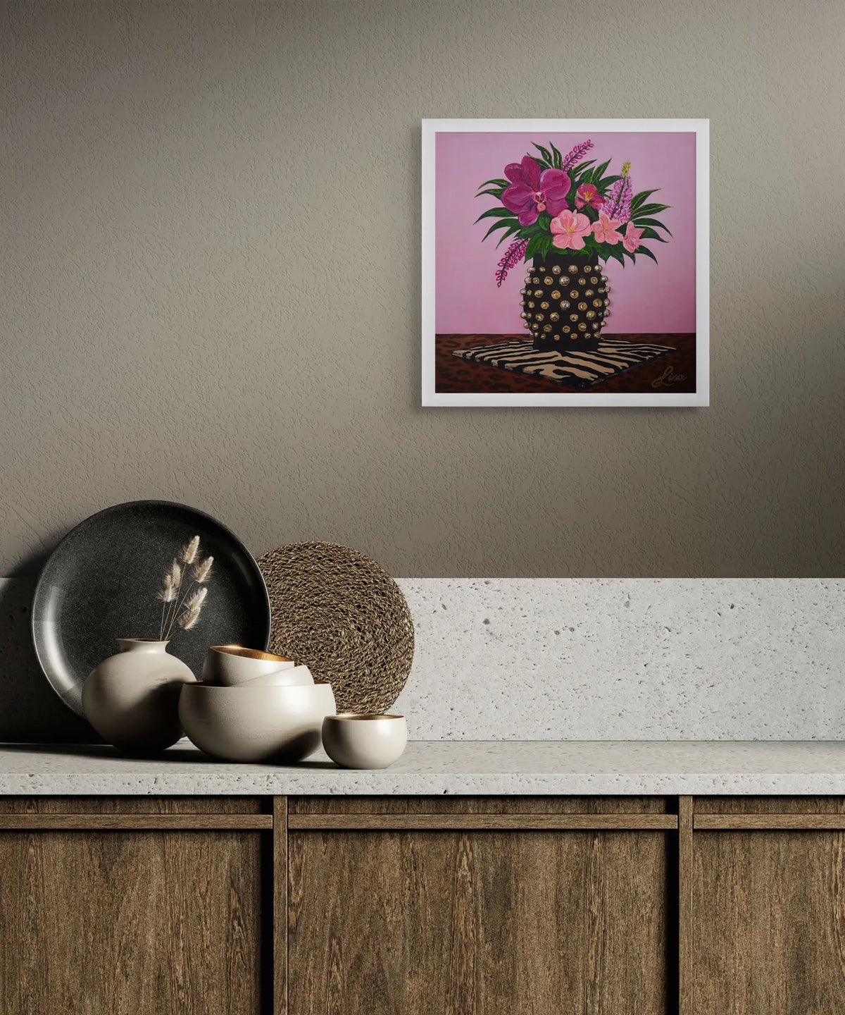 Original floral artwork framed and styled above a kitchen bench with minimal interior.