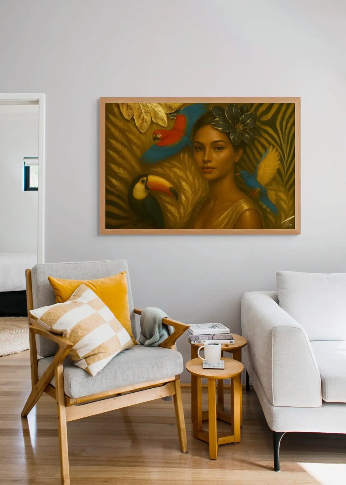 The Gilded Aviary displayed in an oak frame above a grey chair in a contemporary living room interior mockup.