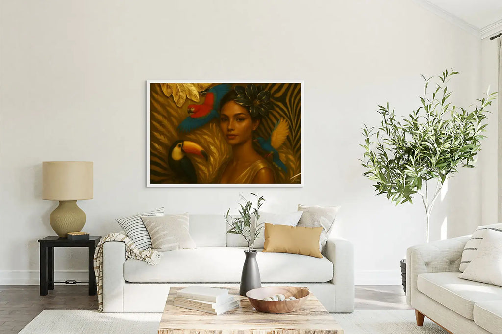 The Gilded Aviary original painting in a white frame styled above a white sofa in a bright, modern lounge setting.