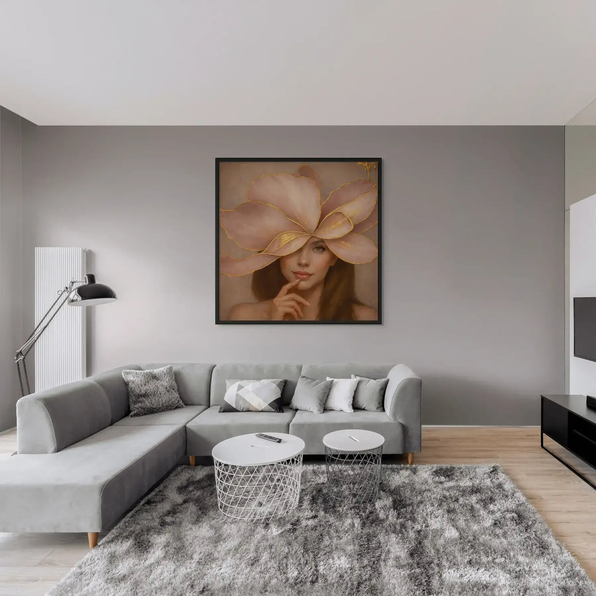 Luxury gold leaf portrait painting Gilded Honey II displayed in a black frame above a grey sectional sofa in a modern minimalist living room.