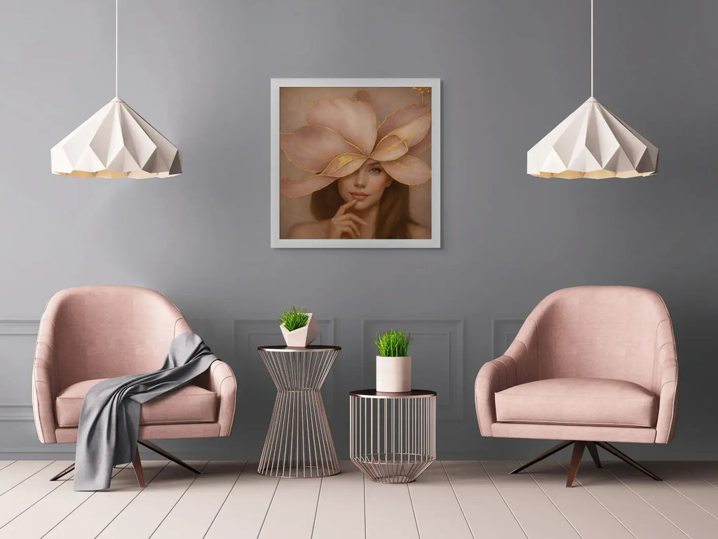 Luxury gold leaf portrait painting Gilded Honey II displayed in a white frame between blush pink velvet chairs in an elegant modern sitting area.
