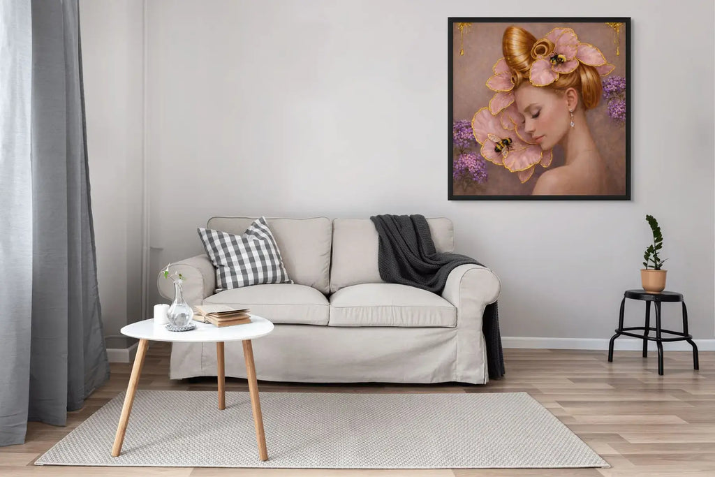 Luxury gold leaf portrait painting Gilded Honey III presented in a black frame above a neutral sofa in a modern living room.