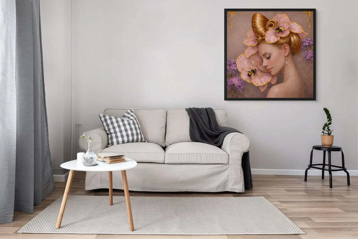 Luxury gold leaf portrait painting Gilded Honey III presented in a black frame above a neutral sofa in a modern living room.