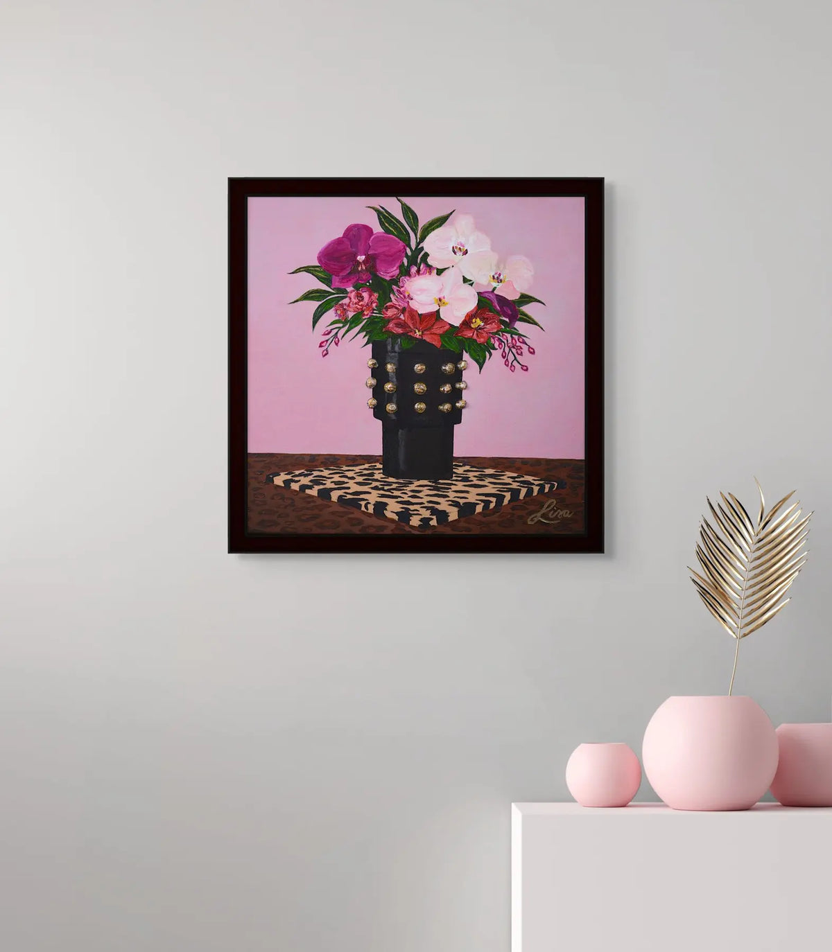 Original floral artwork styled with a pink vase accent on a console table.