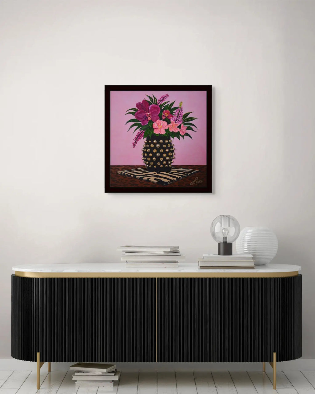 Original floral painting in a black frame displayed above a black console table.
