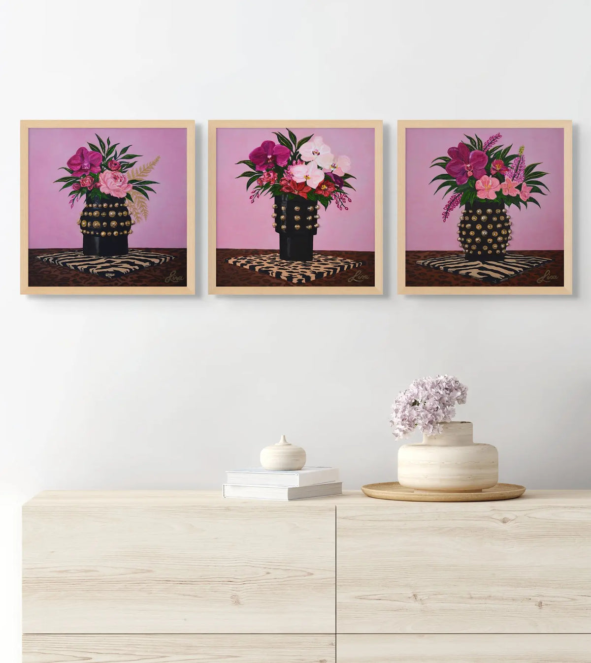 Original floral triptych paintings framed in oak and styled above a modern console.